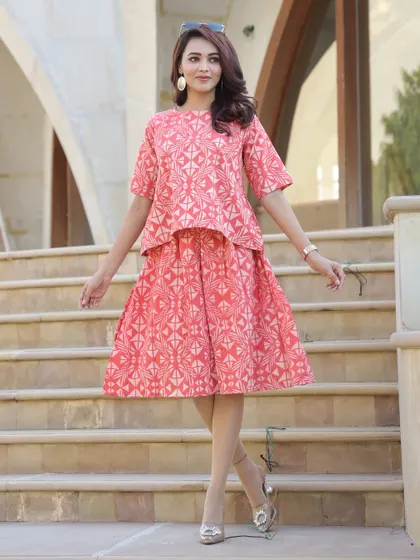 This co-ord set in a lovely coral pink features a geometric Bagru print. The top has a 20-inch length and the skirt is 25 inches long, creating a balanced look.