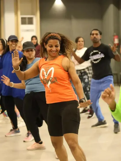 Waving and smiling during a fun routine at the Kannur ZIN meet up.