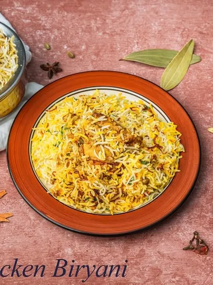 A timeless classic, our Chicken Biryani is made with fragrant basmati rice, tender chicken pieces, and a blend of aromatic spices, slow-cooked to perfection. Served with a side of cooling raita.