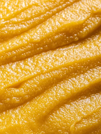 A macro shot that emphasizes the pure, grainy quality of the ghee. Capturing these details is crucial for D2C food brands that pride themselves on quality ingredients.