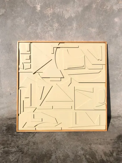 A full view of the 'Dreamscape' relief art against a concrete wall, highlighting its minimalist and architectural quality.