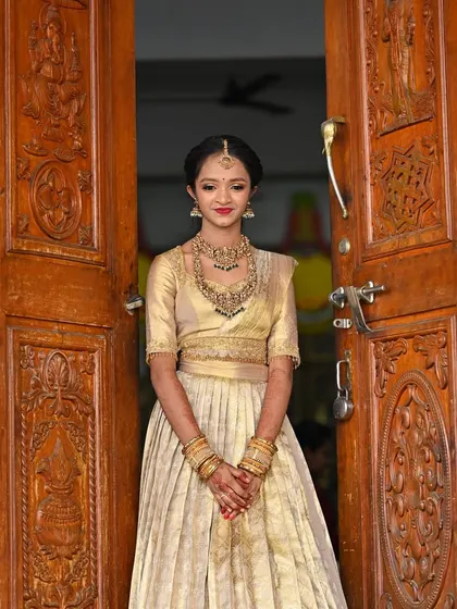 Another look at the custom all-gold Langa Davani. The outfit's elegance is highlighted by the traditional wooden door backdrop, showcasing its timeless appeal.