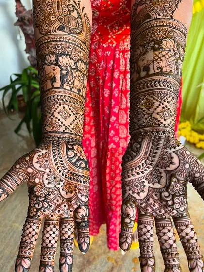 A top-down view of the peacock and elephant bridal design, showing the symmetry and balance of the artwork.