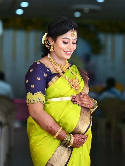 A beautiful, candid moment of an expecting mother cradling her belly. The intricate mehendi on her hands adds another layer of tradition and beauty to her baby shower celebration.