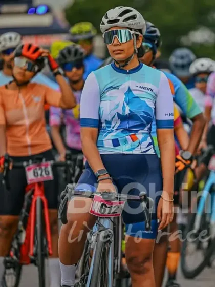 A female rider, poised and ready at the start line. I am committed to creating an equal and empowering environment for all women in cycling.
