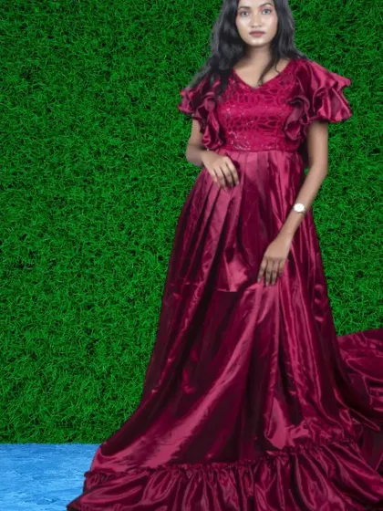 A rich maroon satin gown with flutter sleeves and a ruffled hem. The deep color and flowing fabric create a very romantic and dramatic look.