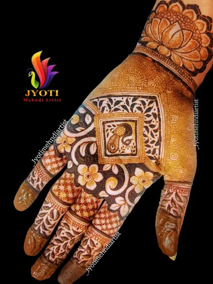 A beautiful example of an Indian design with a central peacock figure, surrounded by floral patterns and detailed work on the fingers.