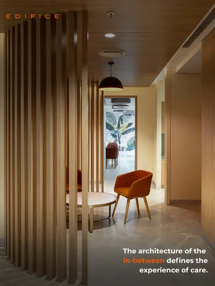 The architecture of the in-between defines the experience of care. Here, a semi-private seating nook is created using a wooden slat partition, offering a quiet space for conversation or reflection away from the main corridor.