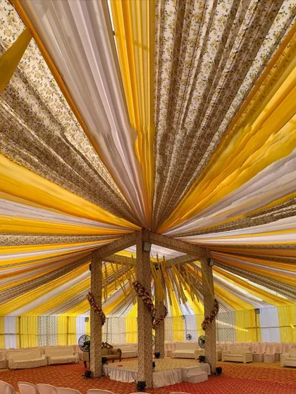Another perspective of the grand draped Haldi mandap, looking up into the intricate canopy. The radiating lines of fabric create a stunning visual effect.