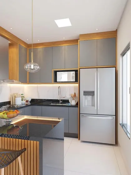 A full view of the grey and wood kitchen, showing the layout with the refrigerator, built-in microwave, and L-shaped counter.