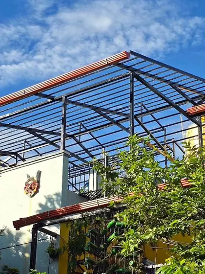 The view of the terrace work from a distance. The goal is to integrate these sustainable upgrades seamlessly into the existing green canopy of our home.