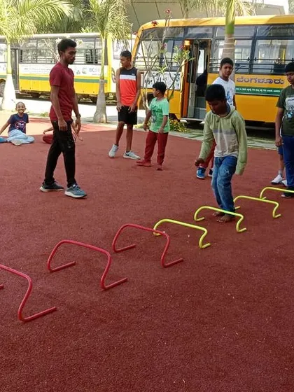 More students navigate the hurdle course, a great way to build fitness and have fun during summer camp.