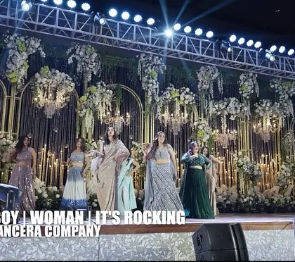 A wide shot capturing the grandeur of the bridesmaids' performance. The stunning floral decor and stage lighting made this a visual treat.