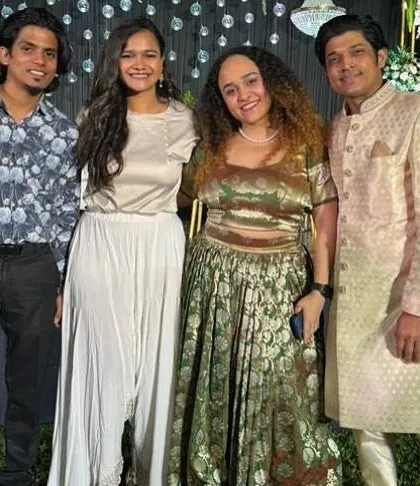 Posing with friends and guests at a beautiful outdoor wedding event.