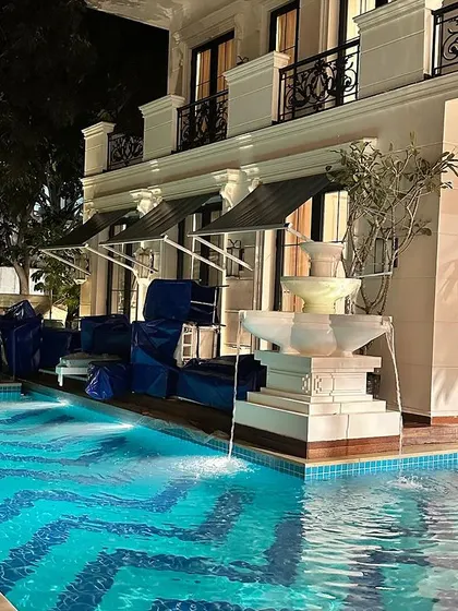 The lighting design for this project highlights both the pool and the architectural details of the home, creating a sophisticated evening ambiance.