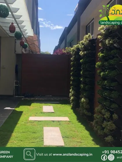 An identical daytime shot, highlighting the healthy plants in the vertical wall system and the neat stone pathway.