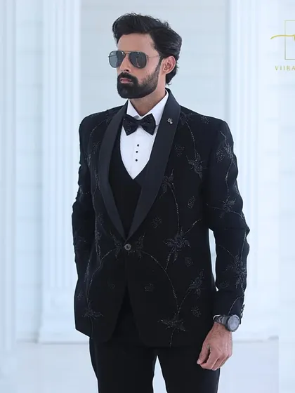 This black-on-black embroidered tuxedo is a favorite among grooms for its understated elegance. The floral pattern adds a modern twist to the classic black tuxedo.