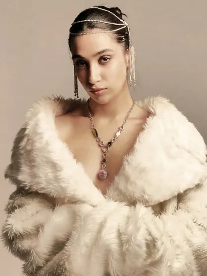 A different angle of this artistic, high-fashion look. The clean makeup allows the unique jewelry and textures of the fur coat to take center stage.