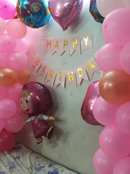A sweet 'Masha and the Bear' theme for a little one's birthday. We use pink and rose gold balloons, character foil balloons, and a 'Happy Birthday' banner to create a charming party atmosphere at home.