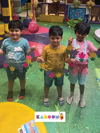 A group of friends proudly displays the festive paper torans they created together during one of our holiday craft sessions. Crafting is always more fun with friends!