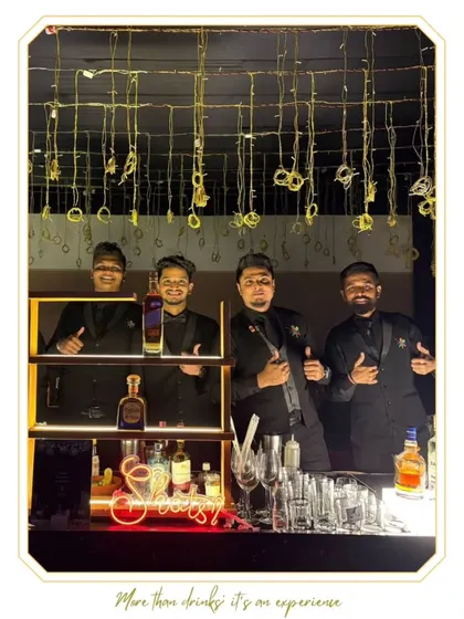 Our team posing at a sleek, modern bar setup. Their professional appearance and confident smiles reflect our brand's high standards.
