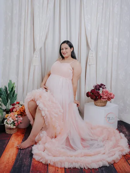 A beautiful full-length portrait showcasing the stunning details of the ruffled gown. The soft lighting creates a dreamy and romantic feel.