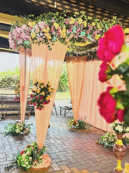 A close-up, artistic shot of the peach floral arch, highlighting the soft colors and delicate arrangement of the flowers.