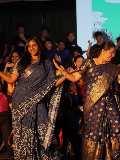 Sharing a dance moment on stage with a fellow teacher and my students. I believe dance is a collaborative art, and I love creating an environment where everyone feels included and can enjoy the performance together.