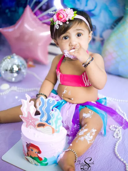 Enjoying every last bite. This close-up shot captures the sensory delight of a first birthday cake, a memory that is as sweet as it is fleeting.