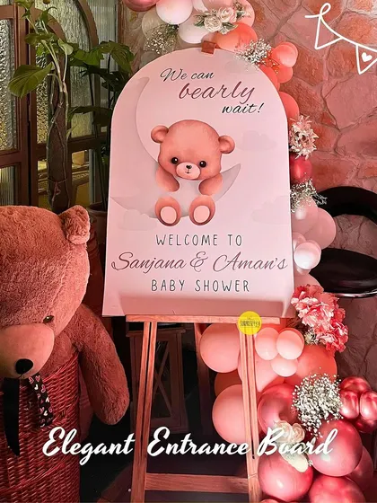 An elegant entrance board for Sanjana and Aman's "We can bearly wait" baby shower. A large teddy bear and a beautiful balloon arrangement welcomed guests to the celebration.