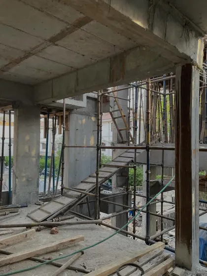 **Dwelling in Splits, Ahmedabad:** The staircase area during construction. Even in its raw state, the flow between the split levels is apparent, promising a home where movement and connection are central to the experience.