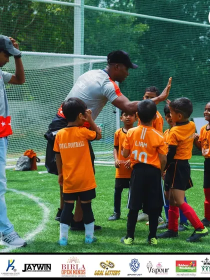 Positive reinforcement is key to building confidence. Our coach shares a high-five with our young players during a tournament, fostering a supportive and encouraging atmosphere.
