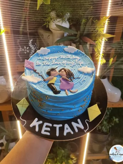 A romantic, custom cake showing a couple flying a kite. This was a special request that I loved bringing to life with hand-piped details and fondant figures.