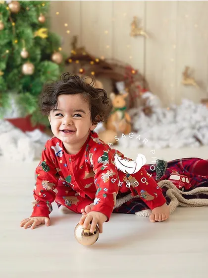 The perfect shot of a baby on the move. This crawling portrait captures the joy and energy of a baby exploring a festive holiday set.