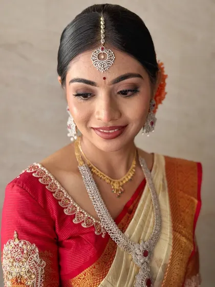 Jahnavi's smile says it all. This close-up shows the flawless application of her bridal makeup, designed to last through the long ceremony while looking fresh and radiant.