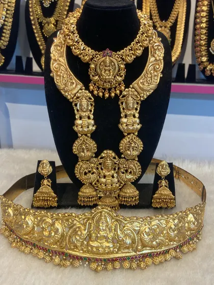 A heavy, sculptural temple jewellery set with a matching Vaddanam. This is for the bride who wants to make a grand, unforgettable statement.
