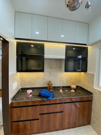 Another view of the kitchen during setup, showing the combination of wood-finish and white cabinets.