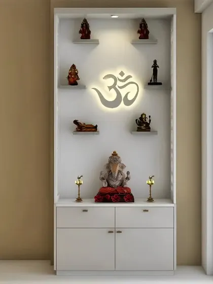 A compact and modern pooja unit in a clean white finish. The backlit 'Om' creates a divine glow, and the open shelves provide a beautiful way to display various deities.