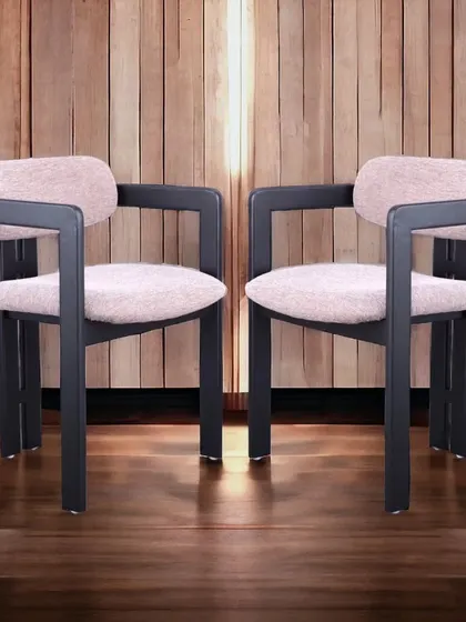 A premium dining chair with a bold, modern design. The thick, angular frame contrasts with the soft pink fabric, creating a unique and luxurious look.