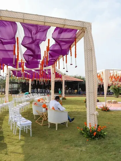 For the bride who dreamt of a purple Haldi, we brought her vision to life. This outdoor setup combines vibrant purple drapes with traditional orange marigolds, creating a unique and festive atmosphere for the ceremony.
