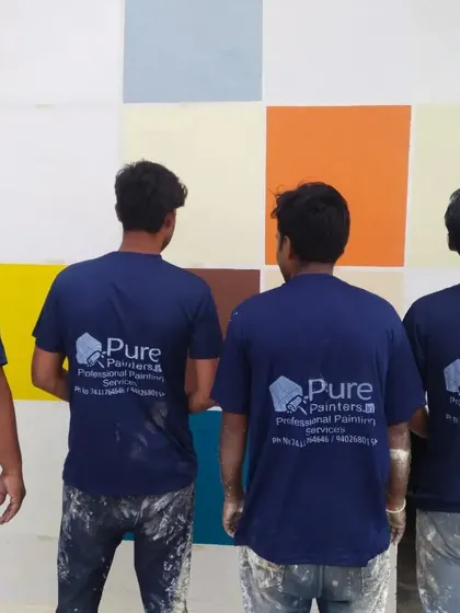 The team stands proudly in front of a color swatch wall, representing our organized and professional approach to painting services.