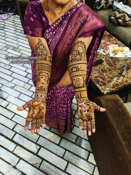 A mother of the bride or a close family member with full-arm mehndi, showing that this elaborate style is for anyone who wants to celebrate.