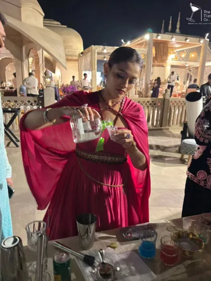 A guest at a wedding takes her turn behind the bar during our interactive cocktail workshop. We love creating opportunities for guests to get involved and make their own drinks.