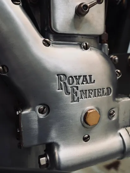 The beautifully restored Royal Enfield engine casing, showing the original cast texture and branding from 1955.