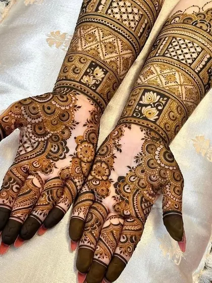 A stunning, heavy bridal-style design perfect for a grand Eid celebration. The arms are covered in intricate geometric bands, while the hands feature detailed floral and paisley work.