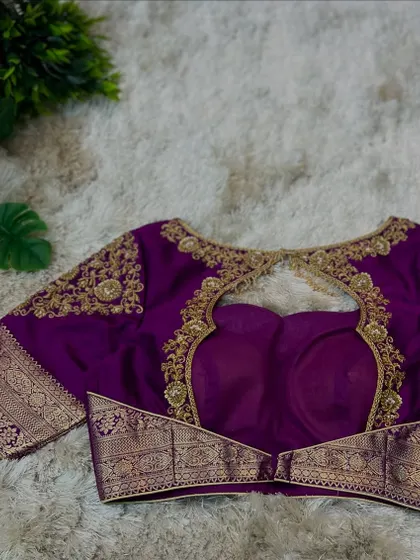 A full view of the purple blouse with its distinctive back cut-out and embroidered sleeves.