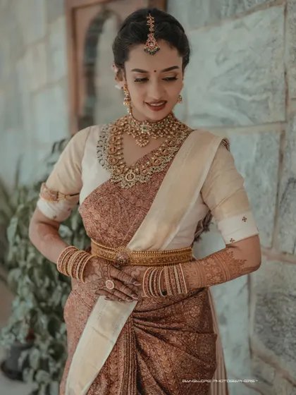 A portrait of timeless South Indian bridal beauty. I focus on capturing the intricate details of the silk saree, the temple jewelry, and the bride's serene expression.