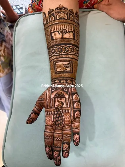 The front of a traditional bridal hand, featuring a graceful peacock in a jharokha (window), swan motifs, and other story elements, all crafted with precision and love.