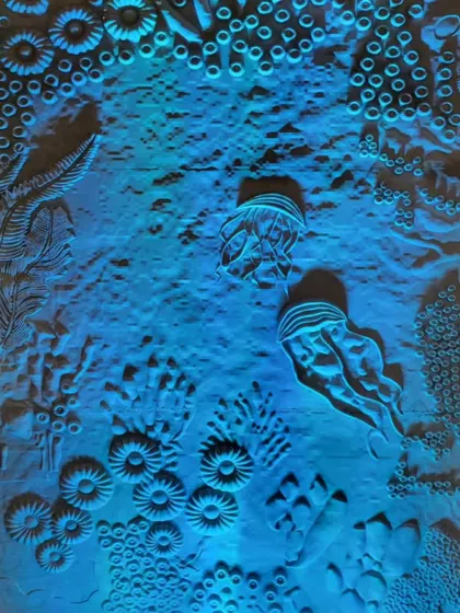Another view of the coral wall illuminated in blue. The lighting design was critical to the story, representing the cool, vibrant life of a healthy reef that is now under threat.