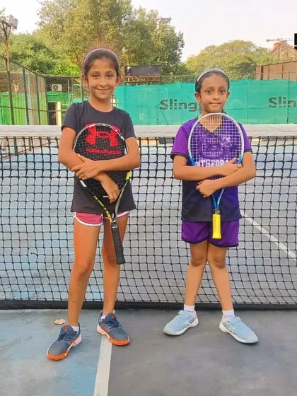 Two of our young female players ready for their match at the inter-school MSSA tournament, showcasing the growing talent in girls' tennis.